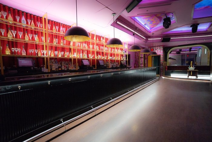 Abigail's bar with red booths under gold arches